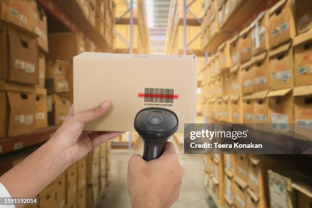barcode scanner in front of modern warehouse - barcode scanner stock-fotos und bilder