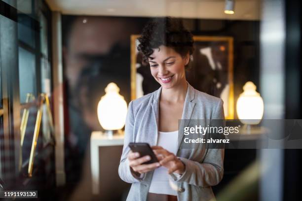 donna d'affari in piedi un corridoio dell'hotel - portable information device foto e immagini stock