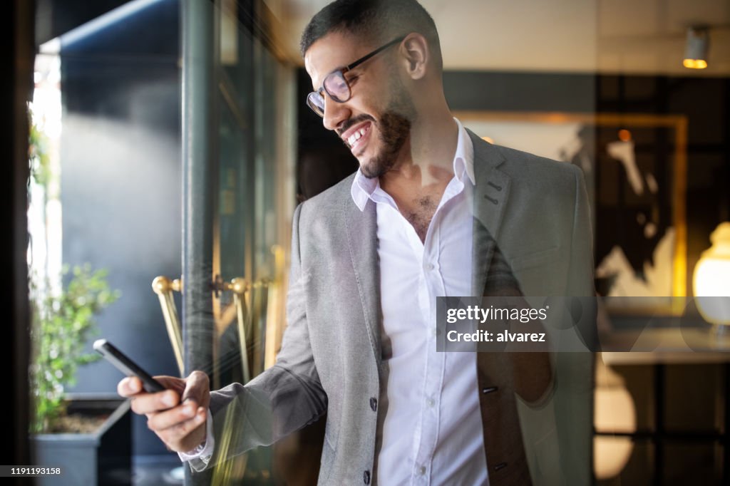 Businessman booking an online taxi from his phone