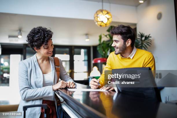 tourist registering in hotel - hi imagens e fotografias de stock