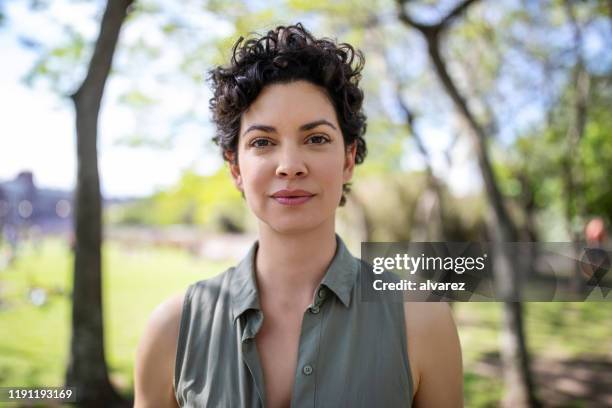 portrait of a confident young woman at the park - casual clothing photos stock pictures, royalty-free photos & images