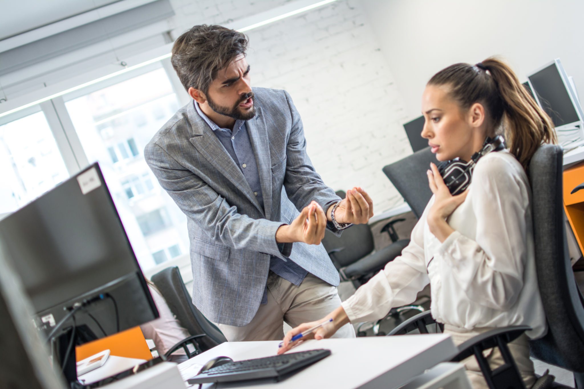 Two business colleagues having disagreement and conflict in office Two business colleagues having disagreement and conflict in office