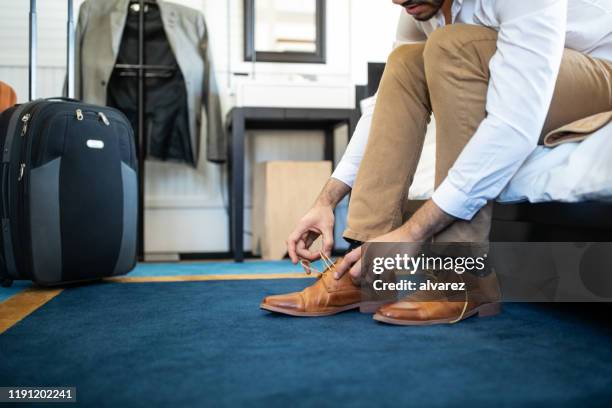 zakenman neemt zijn schoen in hotelkamer - launch of 6 bullets to hell arrivals stockfoto's en -beelden