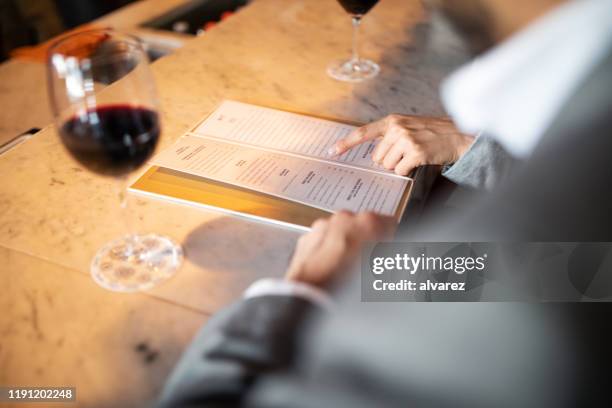 business people discussing menu at a cafe counter - menu imagens e fotografias de stock