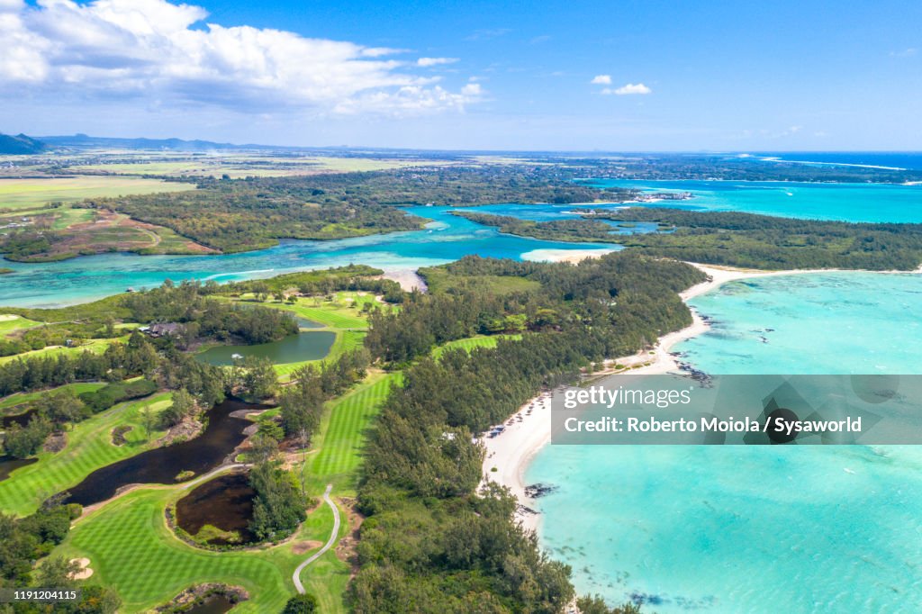Golf course by the turquoise ocean, aerial view, Mauritius