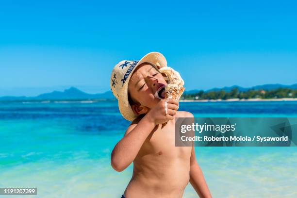 little boy eating an ice-cream on tropical beach, mauritius - beach boys stock pictures, royalty-free photos & images