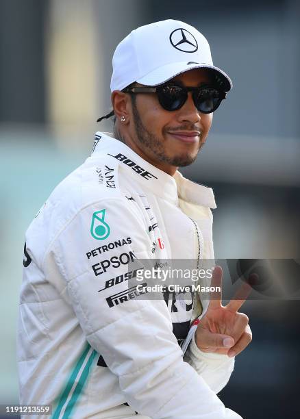 Lewis Hamilton of Great Britain and Mercedes GP waves to fans on the drivers parade before the F1 Grand Prix of Abu Dhabi at Yas Marina Circuit on...