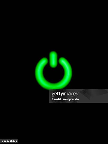 turn on symbol illuminated against black - start button stock pictures, royalty-free photos & images