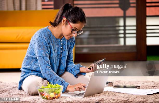 woman working on laptop at home - indian eating healthy stock pictures, royalty-free photos & images