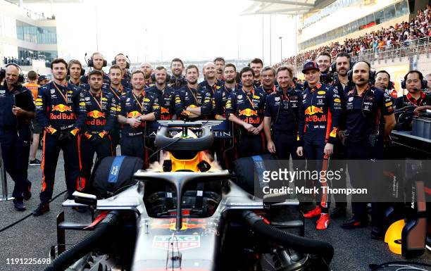 Max Verstappen of Netherlands and Red Bull Racing stands with his team on the grid before the F1 Grand Prix of Abu Dhabi at Yas Marina Circuit on...