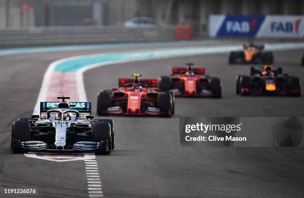 Lewis Hamilton of Great Britain driving the Mercedes AMG Petronas F1 Team Mercedes W10 leads the field on lap one during the F1 Grand Prix of Abu...