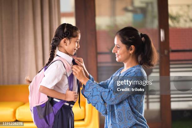 loving mother get ready to her daughter in school uniform at home - indian mother and child stock pictures, royalty-free photos & images