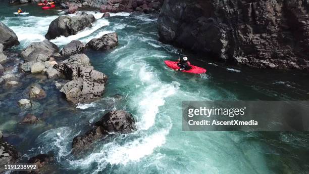 white water kayaker paddles down river to meet friends - white water kayaking stock pictures, royalty-free photos & images