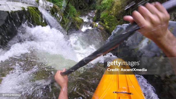 white water kayaker paddles down waterfall - white water kayaking stock pictures, royalty-free photos & images