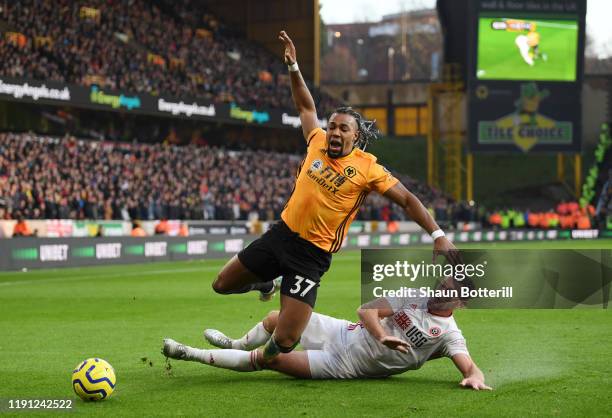 Jack O'Connell of Sheffield United tackles Adama Traore of Wolverhampton Wanderers during the Premier League match between Wolverhampton Wanderers...