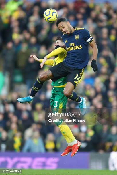 Pierre-Emerick Aubameyang of Arsenal wins a header over Sam Byram of Norwich City during the Premier League match between Norwich City and Arsenal FC...