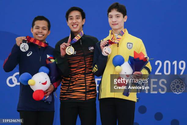 From left, Christopher Caluza of the Philippines, Julian Zhi Jie Yee of Malaysia and Micah Kai Lynette of Thailand celebrate with their silver, gold...