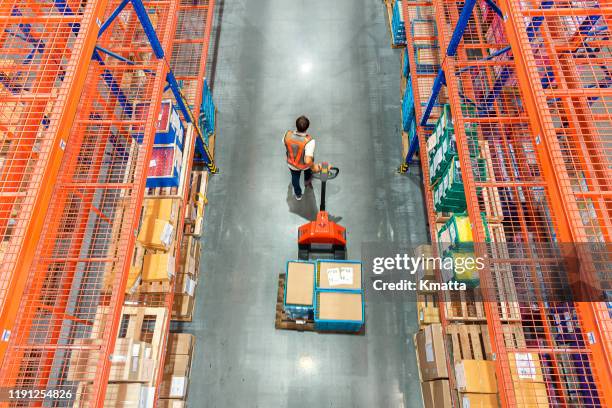 high angle view of male warehouse worker. - storage business stock pictures, royalty-free photos & images