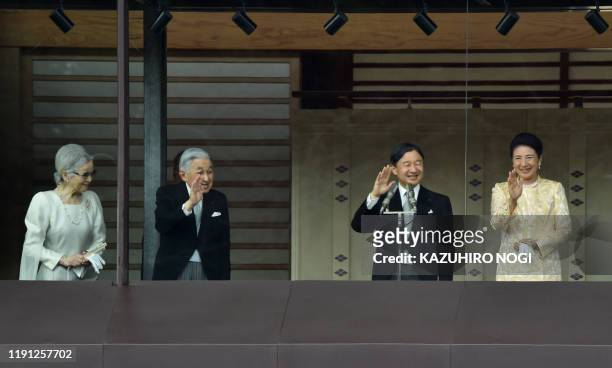 Japan's Emperor Naruhito , Empress Masako , former Emperor Akihito and former Empress Michiko wave to well-wishers from the balcony of the Imperial...