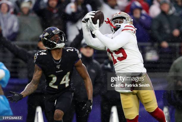 Deebo Samuel of the San Francisco 49ers catches a 33-yard touchdown pass against Marcus Peters of the Baltimore Ravens during the first quarter at...