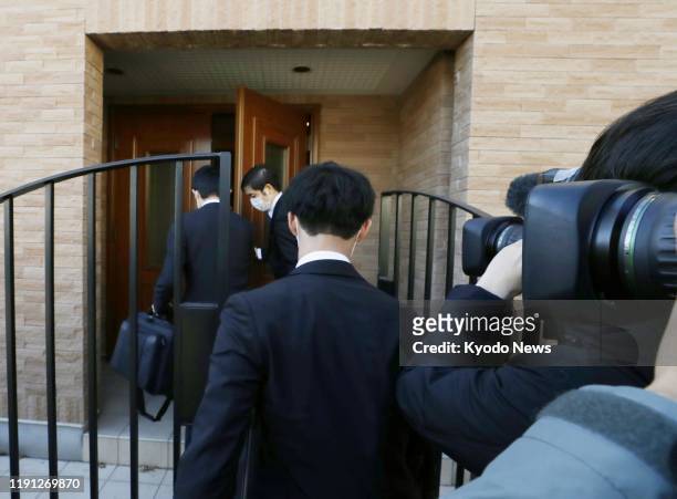 Japanese prosecutors enter Carlos Ghosn's residence in Tokyo on Jan. 2, 2020. The former chief of the Nissan-Renault auto alliance charged with...