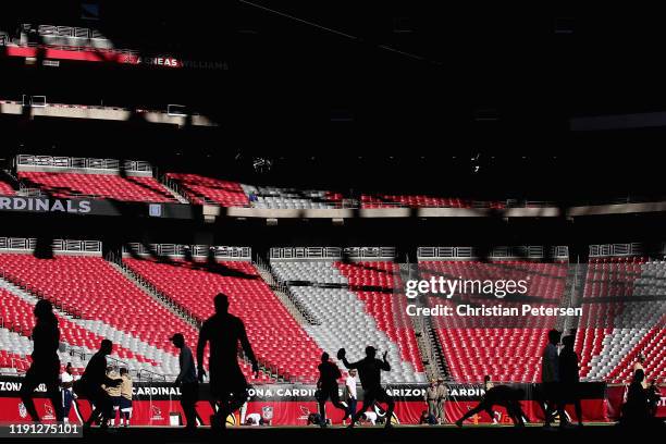 Quarterback Jared Goff of the Los Angeles Rams warms up with teammates before the NFL game against the Arizona Cardinals at State Farm Stadium on...