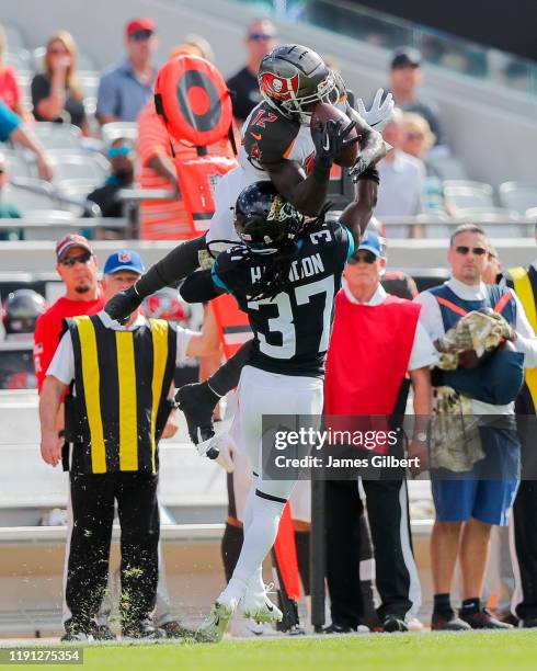 Chris Godwin of the Tampa Bay Buccaneers catches a pass against Tre Herndon of the Jacksonville Jaguars during the first quarter of a game at TIAA...