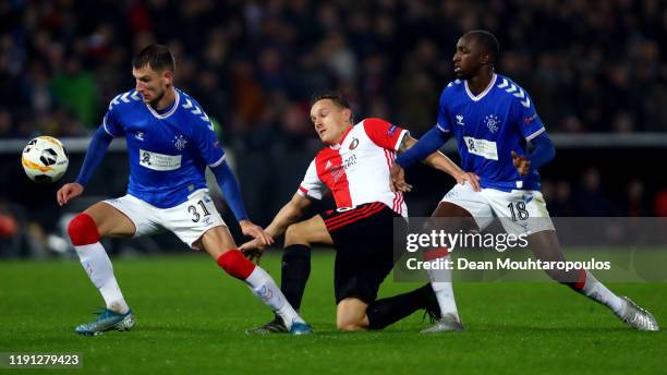 Jens Toornstra of Feyenoord battles for the ball with Borna Barisic and Glen Kamara of Rangers FC during the UEFA Europa League group G match between...