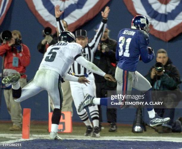 Philadelphia Eagles' quarterback Donovan McNabb pushes New York Giants cornerback Jason Sehorn, after Sehorn intercepted McNabb for a touchdown...