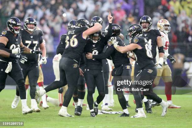 Kicker Justin Tucker of the Baltimore Ravens celebrates after hitting the game winning field goal against the San Francisco 49ers at M&T Bank Stadium...