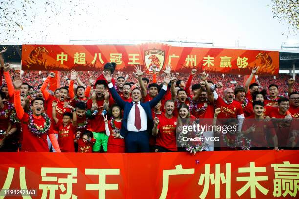 Head coach Fabio Cannavaro of Guangzhou Evergrande and his players celebrate winning the 2019 Chinese Super League title after the 30th round match...