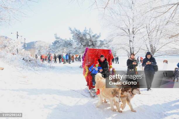 Tourists watch and photograph the new year's first rime landscape, Jilin City, Jilin Province, China, January 1, 2020. - PHOTOGRAPH BY Costfoto /...