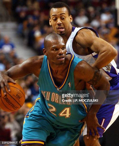 New Orleans Hornets' forward Jamal Mashburn drives to the hoop past Toronto Raptors' forward Chris Jefferies during first half NBA play in Toronto on...