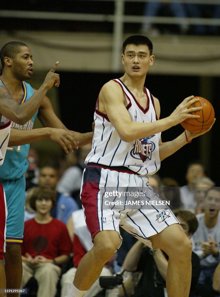 Hornets Rockets 2002 The New Orleans Hornets' Jamaal Magloire guards the Houston Rockets ...