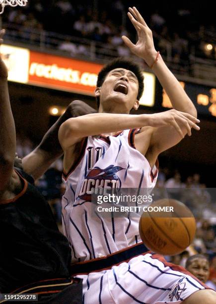 Houston Rockets' center Yao Ming is fouled by Philadelphia 76ers' Olden Plynice during the fourth quarter of their pre-season NBA game at the Compaq...