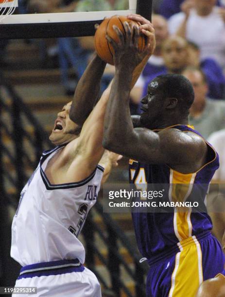 Los Angeles Lakers center Shaquille O'Neal beats a rebound from Sacramento Kings forward Scot Pollard during the first period of the Game Three...