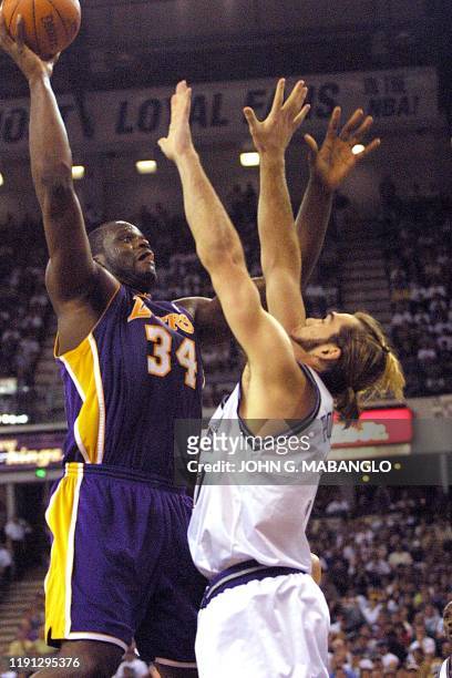 Los Angeles Lakers' center Shaquille O'Neal shoots for two points over Sacramento Kings' forward Scot Pollard during the first period of game four of...