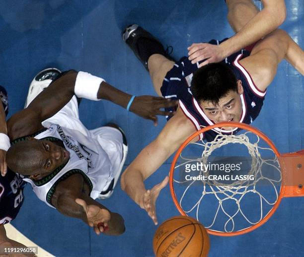 Houston Rockets' Yao Ming goes under the basket for a lay-up past Minnesota Timberwolves' Kevin Garnett in the first quarter of their NBA game 04...