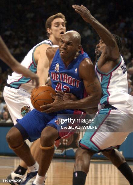 Detroit Piston's Jerry Stackhouse drives to the basket before the Memphis Grizzlies' defence of Pau Gasol of Spain and Michael Dickerson during their...