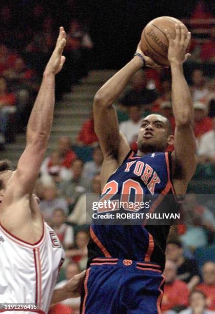 Allan Houston of the New York Knicks shoots over Dan Majerle of the Miami Heat during game one of their first round play-off 08 May 1999 at the Miami...