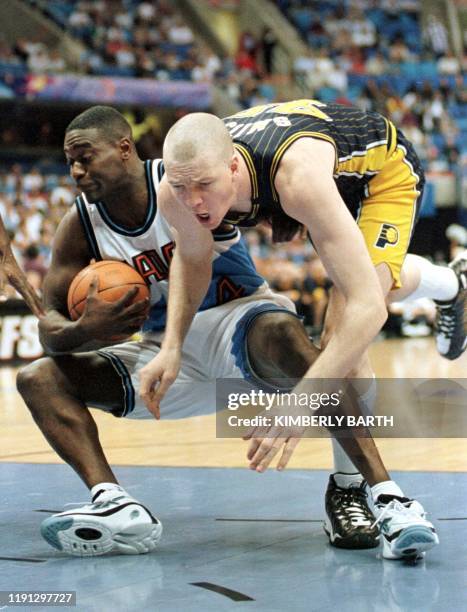 Cleveland Cavaliers forward Shawn Kemp snags a rebound from Indiana Pacers center Rik Smits in game four of the first round of the NBA Playoffs, 30...