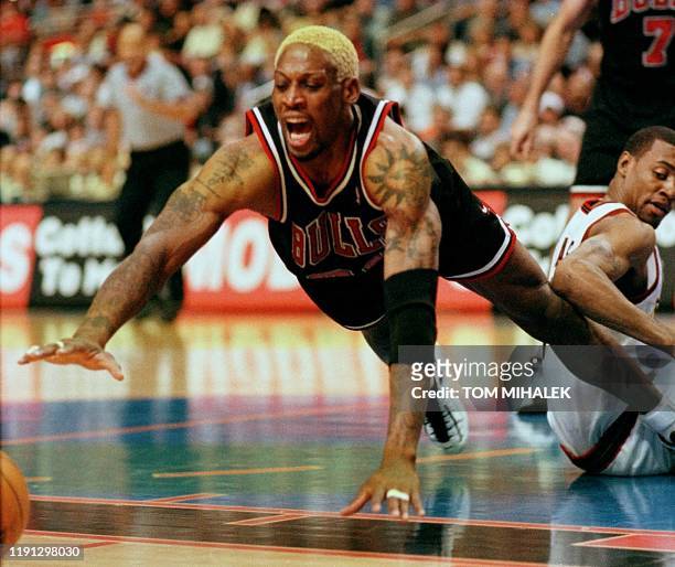 The Chicago Bulls Dennis Rodman dives for the loose ball during their game against the Philadelphia 76ers 17 April in Philadelphia. The Bulls won...