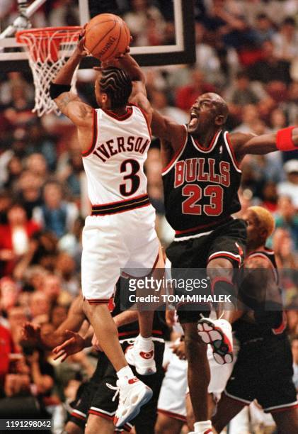 Thiladelphia 76ers Allen Iverson finds the Chicago Bulls Michael Jordan in the path to the basket 17 April in Philadelphia. The Bulls won 87-80,...