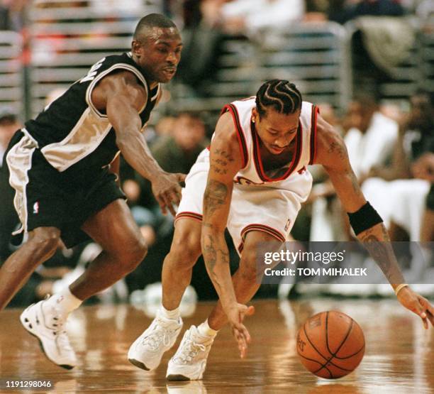 The San Antonio Spurs' Avery Johnson chases the Philadelphia 76ers' Allen Iverson who pursues the loose ball in the 12 February game in Philadelphia....