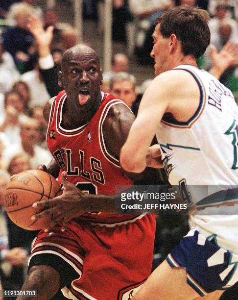 Michael Jordan of the Chicago Bulls tries to drive past Jeff Hornacek of the Utah Jazz 03 June during the second half of game one of the NBA finals...