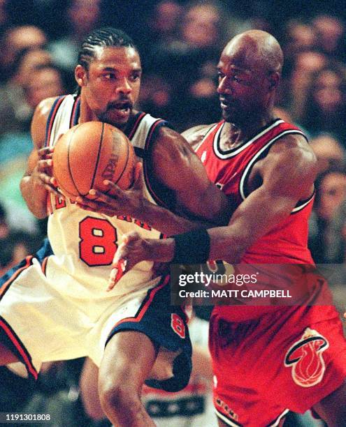 New York Knicks guard Latrell Sprewell tries to keep the ball away from Miami Heat guard Terry Porter in the first quarter 05 May 1999 at Madison...