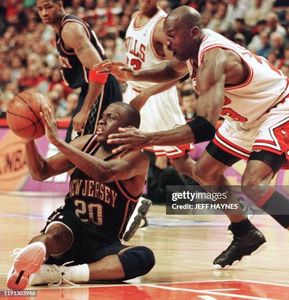 Michael Jordan of the Chicago Bulls tries to grab the ball from Sherman Douglas of the New Jersey Nets 26 April during the second half of game two of...