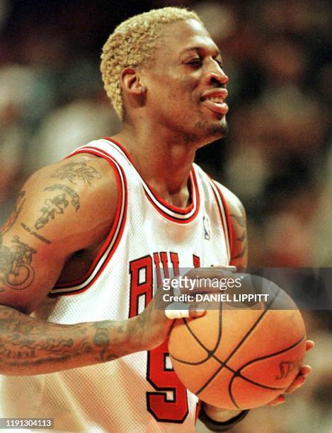 Chicago Bulls forward Dennis Rodman closes his eyes before shooting a free throw against the Detroit Pistons during in overtime during their game at...