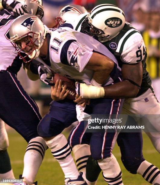 New England Patriots' quarterback Drew Bledsoe gets sacked by the New York Jets' John Abraham on the fourth down with less than two minutes to play...