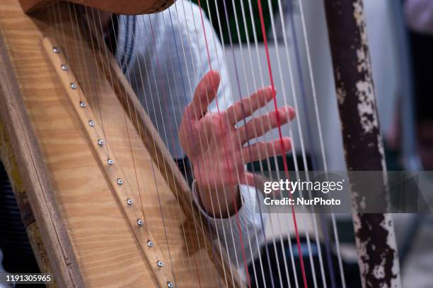 Musician of the Orquesta de Instrumentos Reciclados de Cateura , playing instrument during a rehearsal at the Hotel Leonado before the concert...